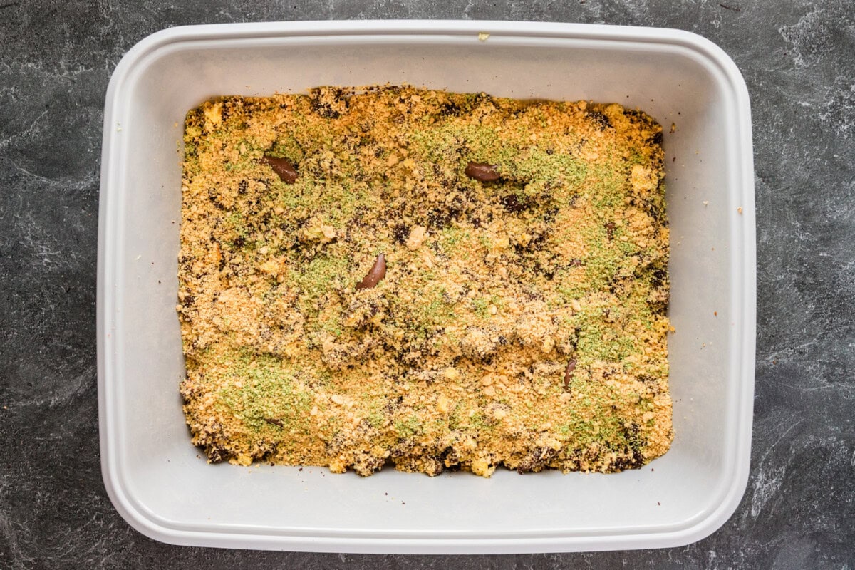 green tined cookie crumbles on top of kitty litter cake