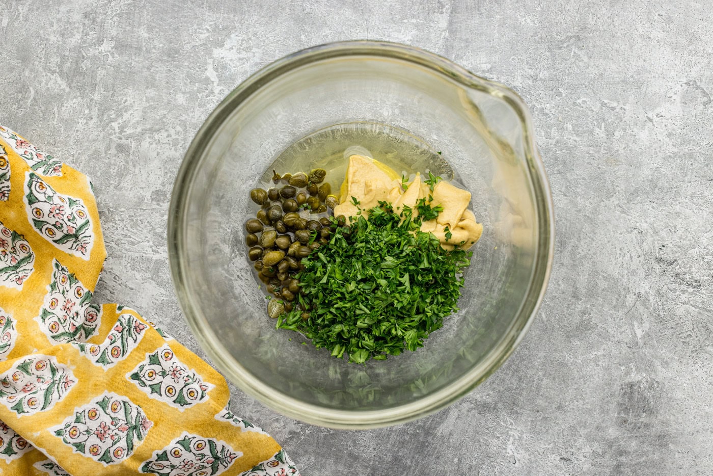 lemon juice, capers, parsley, dijon mustard, and olive oil in a bowl