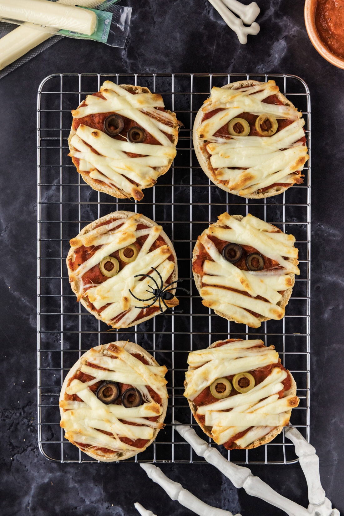 Mini Mummy Pizzas on a wire rack
