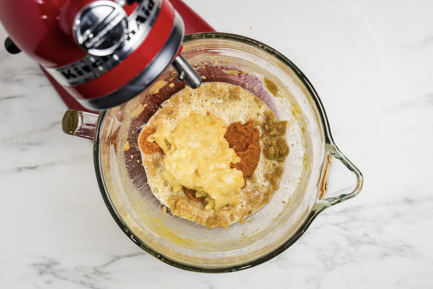 spices, pumpkin, and banana added to mixture in stand mixer bowl