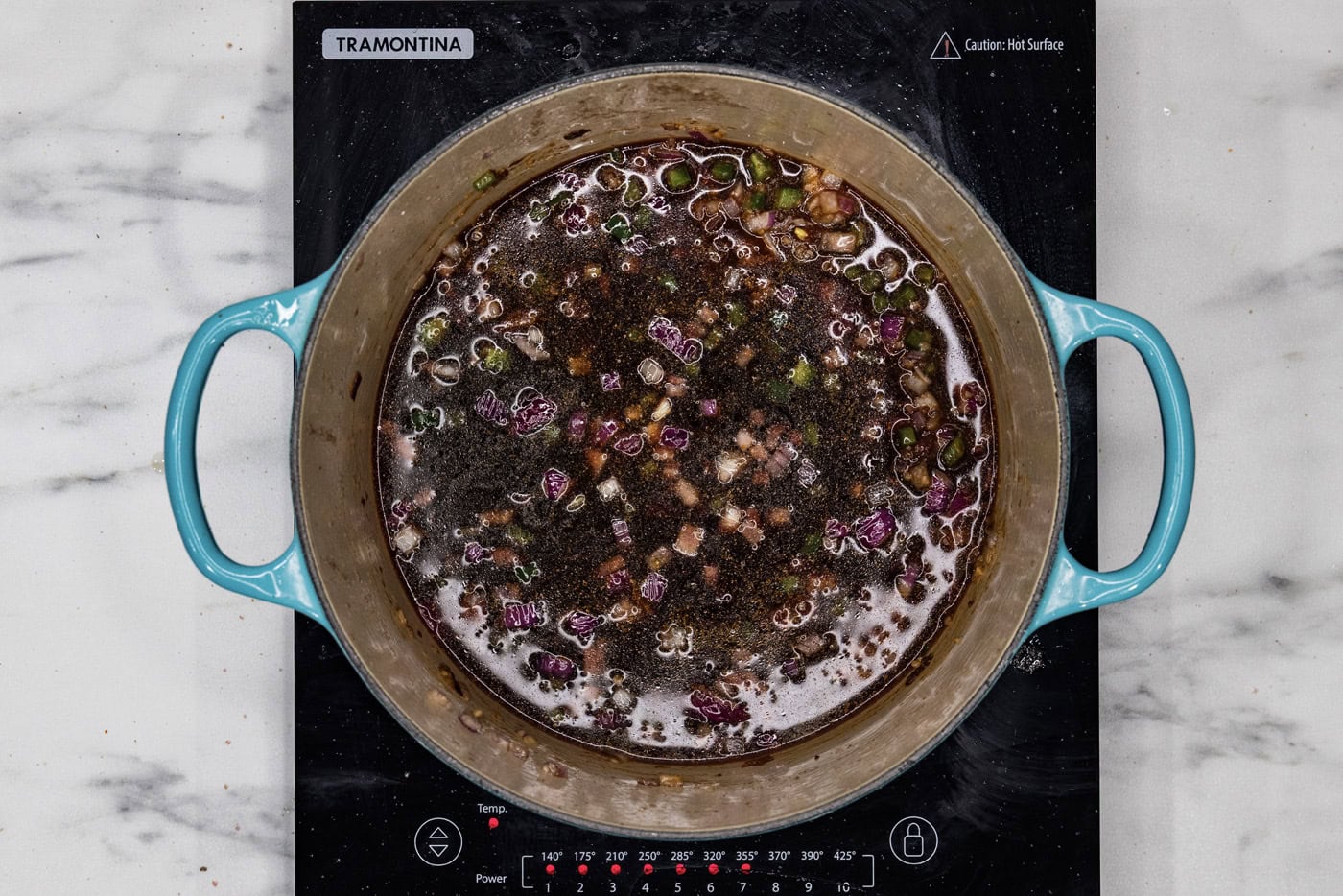 red wine added to dutch oven with sauteed vegetables