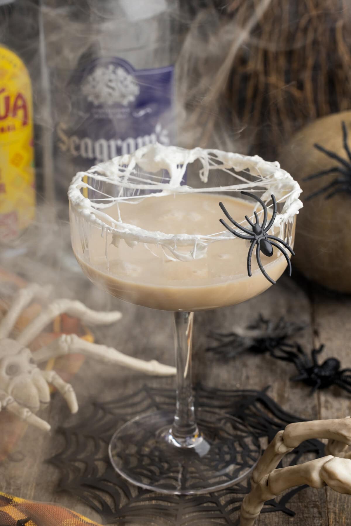 Spiderweb Cocktail with smoke in the background