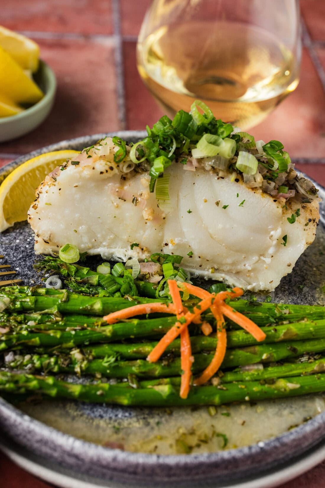 Steamed Chilean Sea Bass on a plate with asparagus