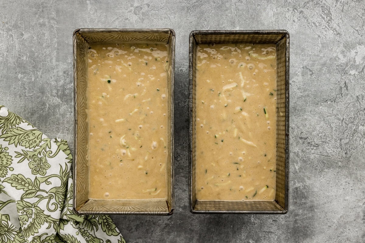 zucchini bread batter in two loaf pans