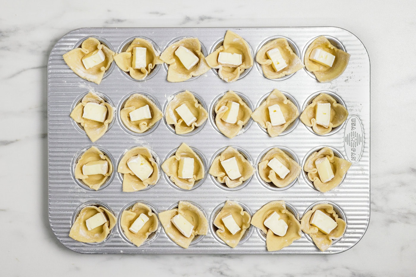 cubes of brie inside puff pastry squares