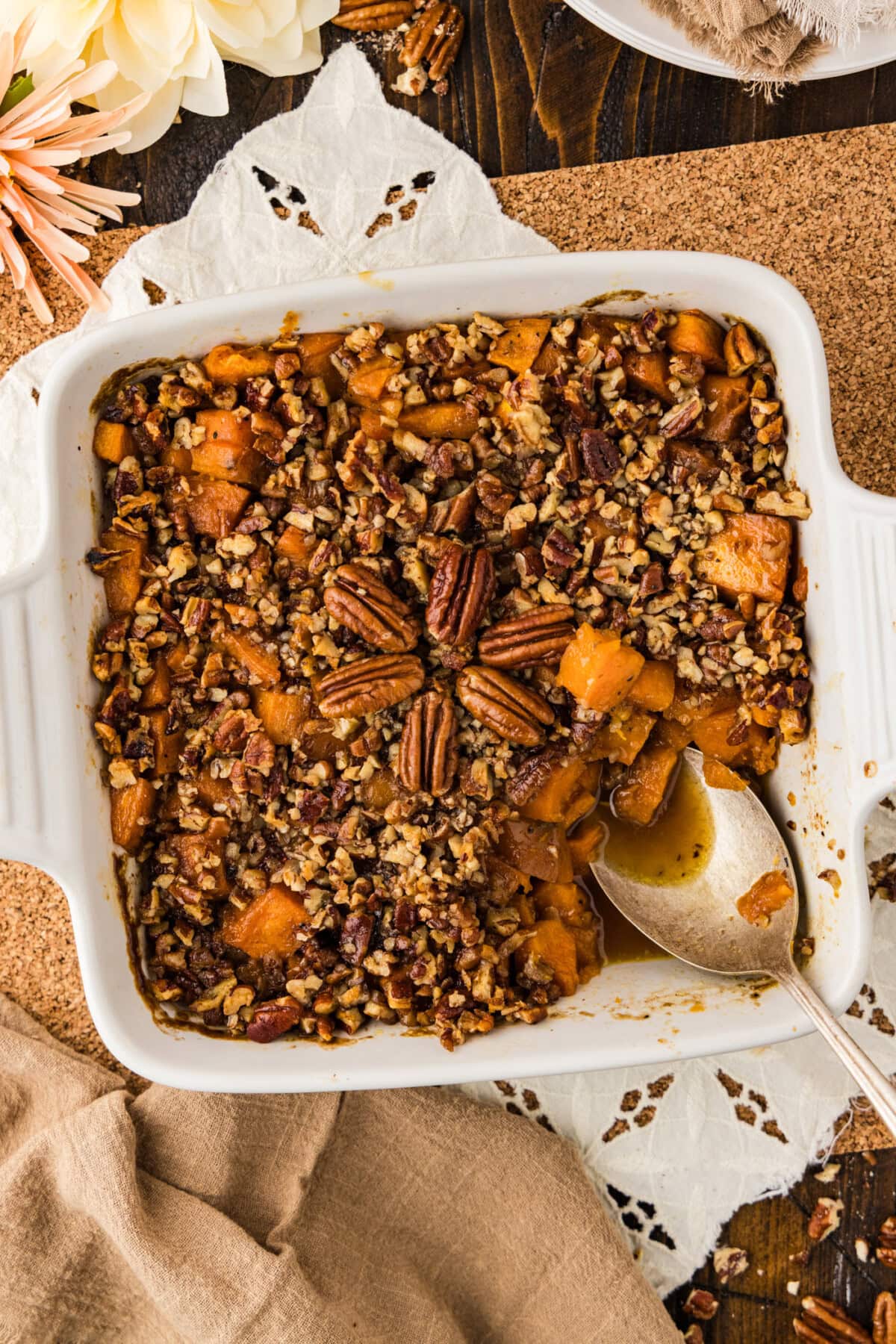 Baking dish of Kentucky Bourbon Sweet Potatoes with a spoon in it