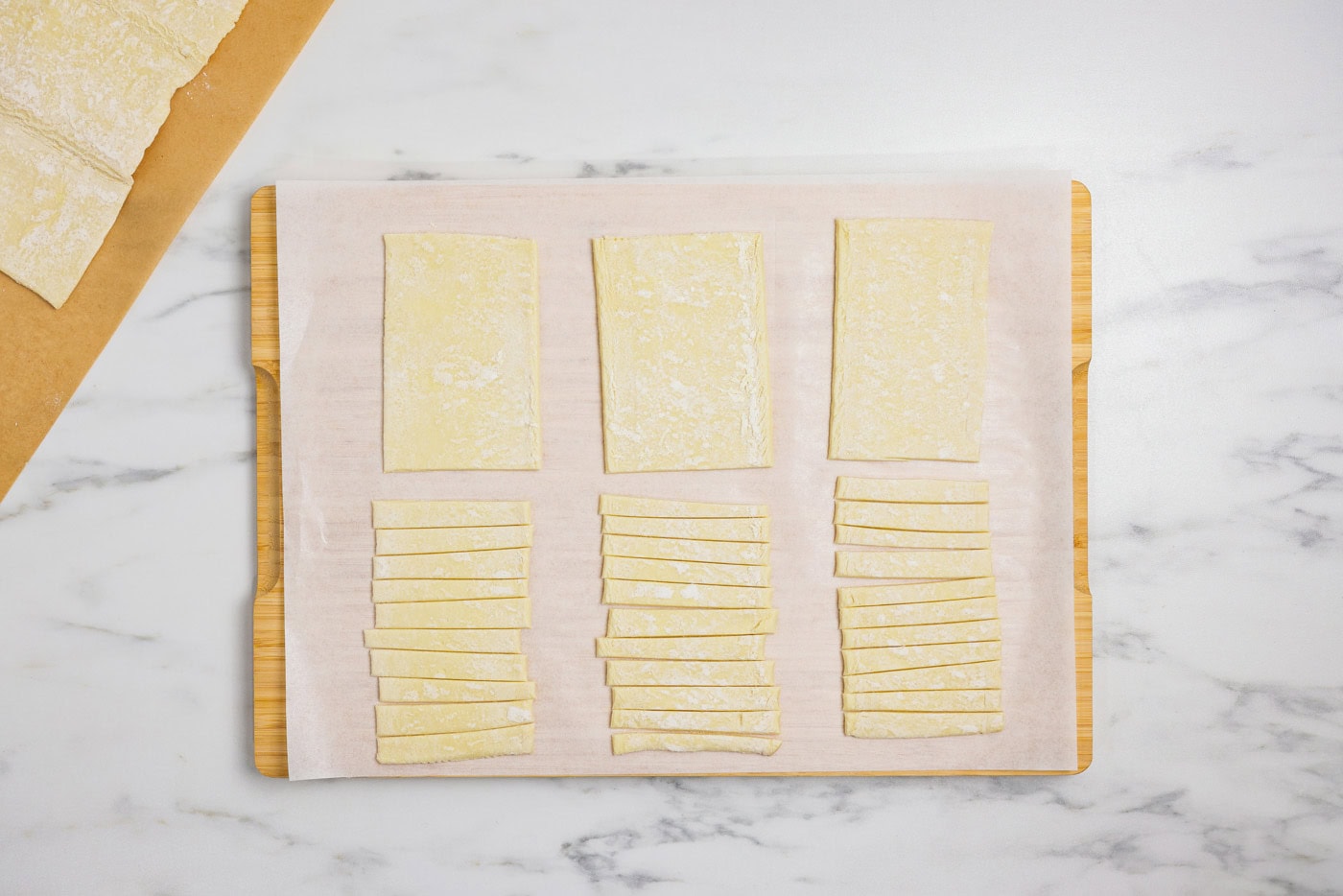 puff pastry cut into sections and strips on a cutting board