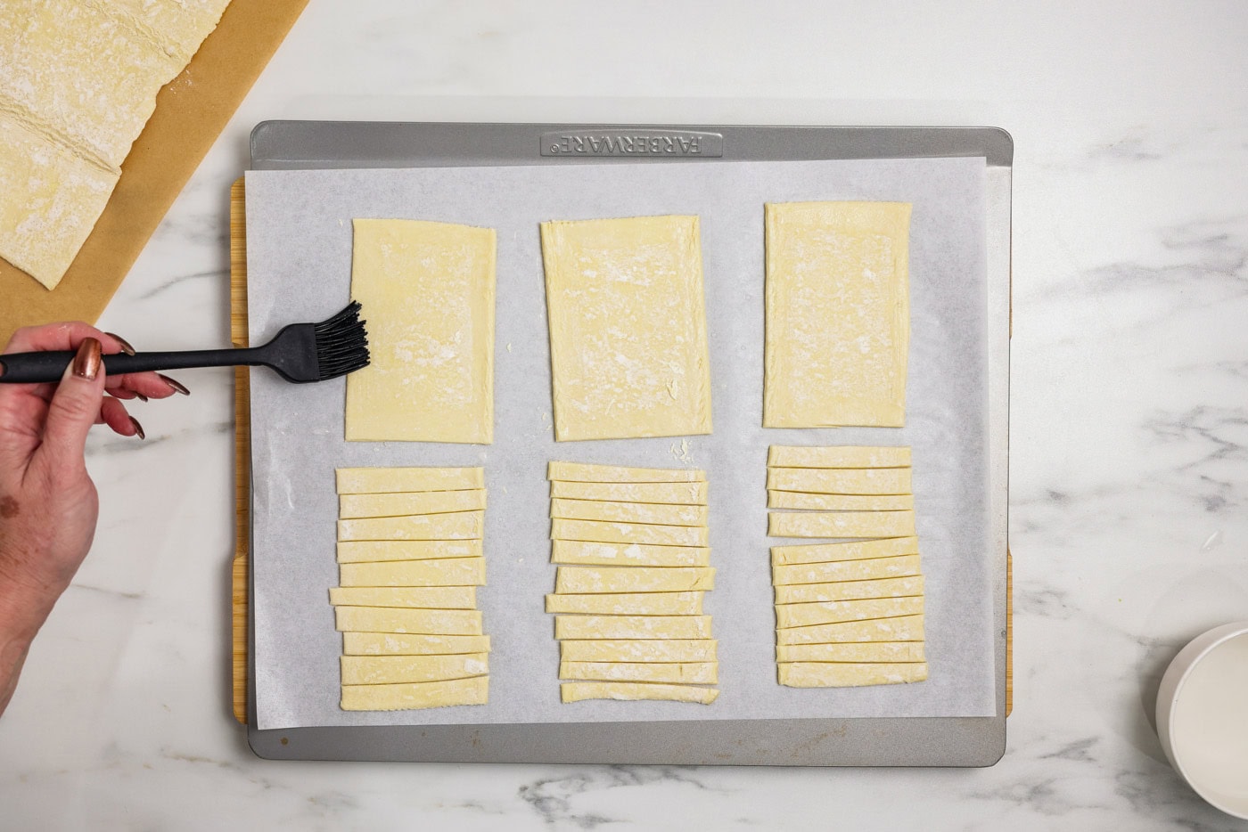 brushing edges of rectangular puff pastry with water