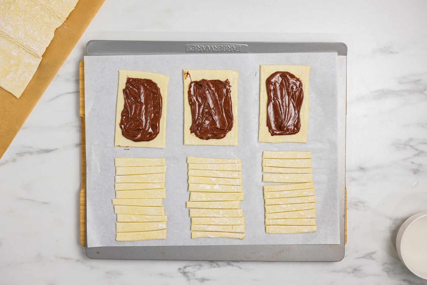 Nutella spread on puff pastry rectangles