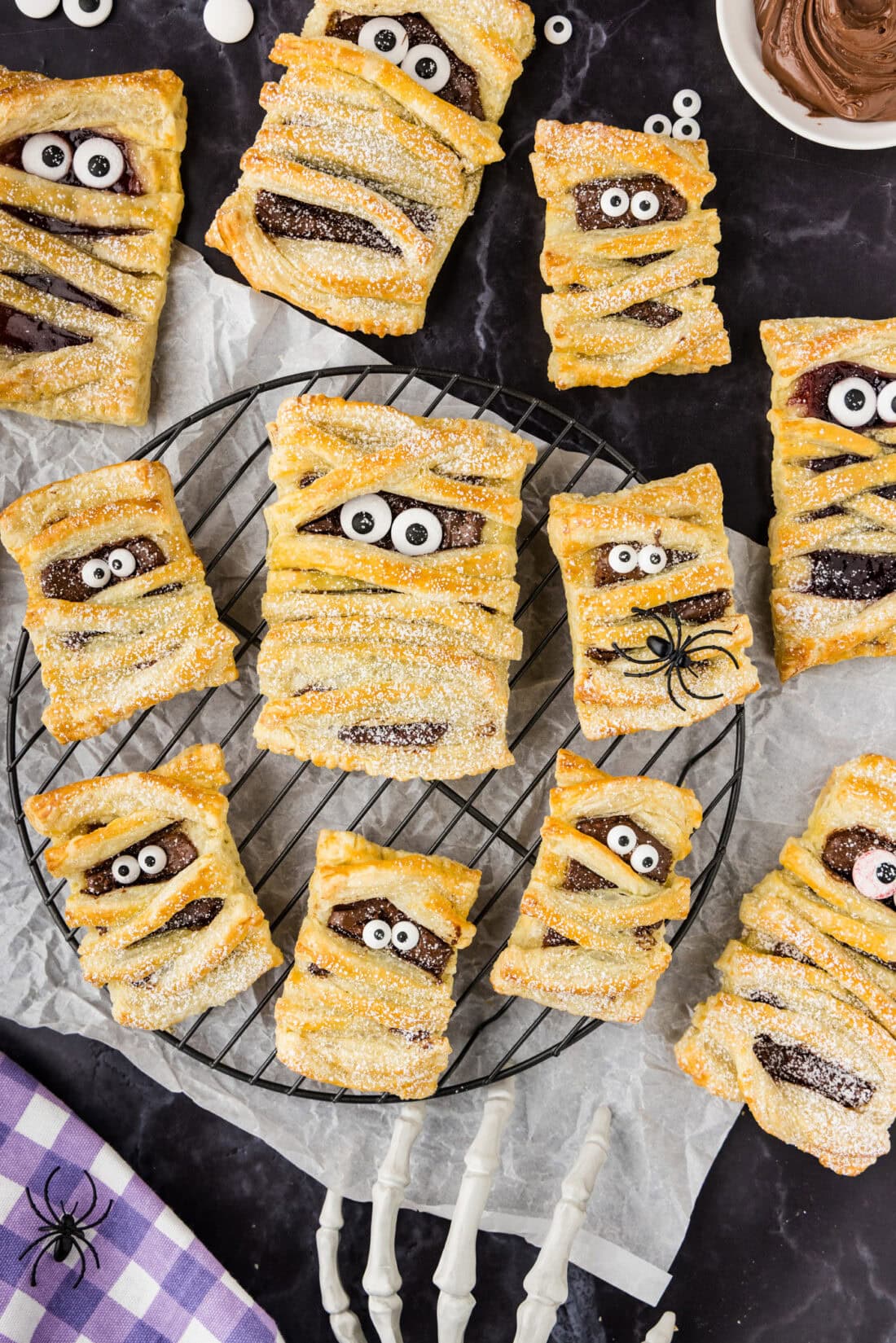 Mummy Hand Pies resting on a wire rack