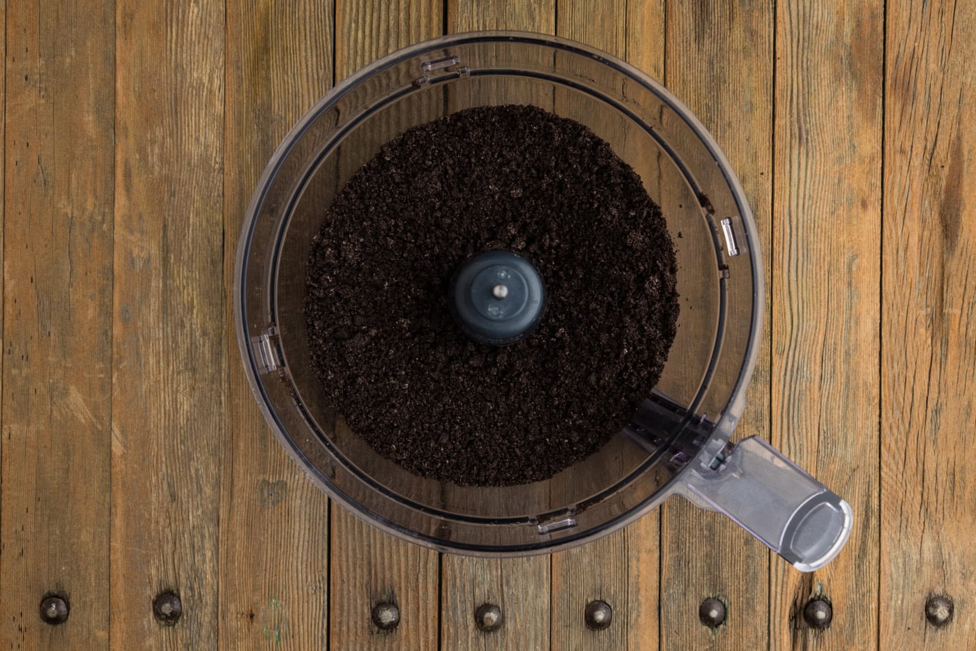 blitzed Oreos in the bowl of a food processor