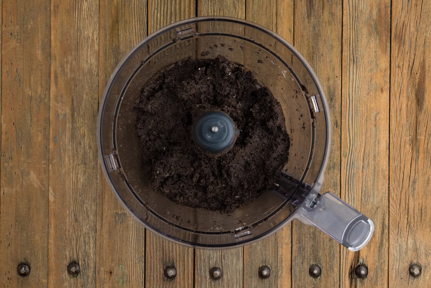 Oreo and cream cheese mixture combined in a food processor bowl