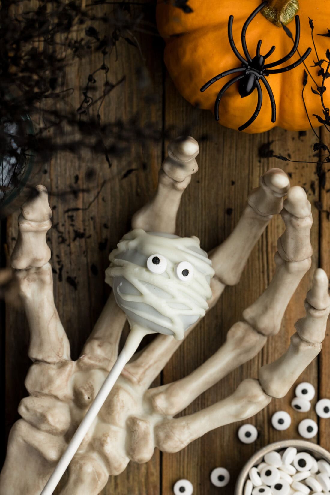 Mummy Pop resting in a skeleton hand