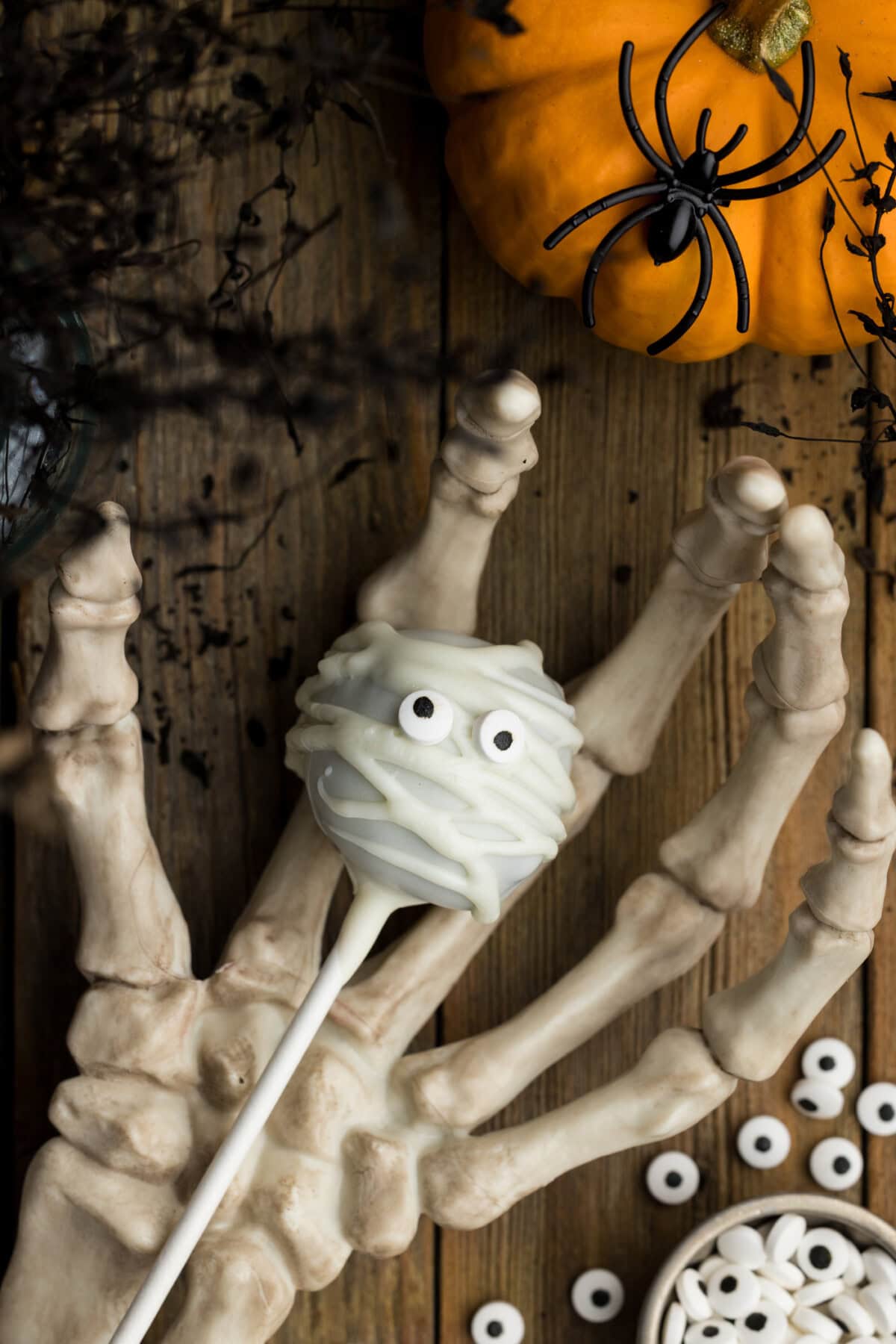 Mummy Pop resting in a skeleton hand