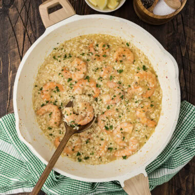Skillet of Shrimp Risotto with a spoon in it
