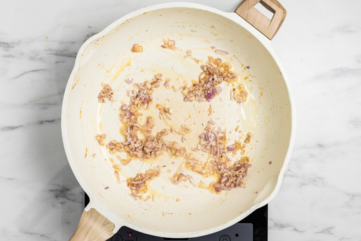 garlic and shallots cooked in a skillet