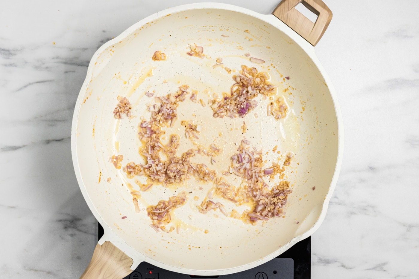garlic and shallots cooked in a skillet
