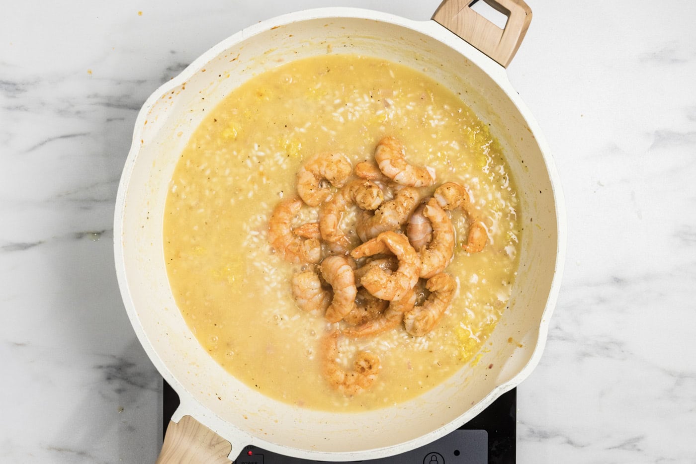 partially cooked shrimp added back to the skillet with risotto mixture