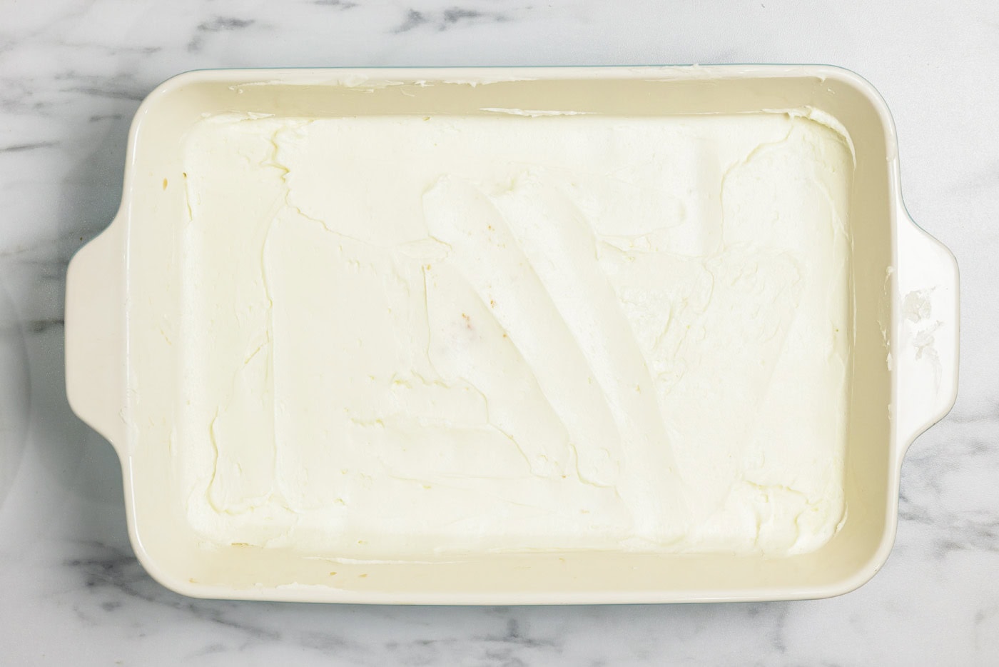 layer of mascarpone cheese mixture over ladyfingers in a dish