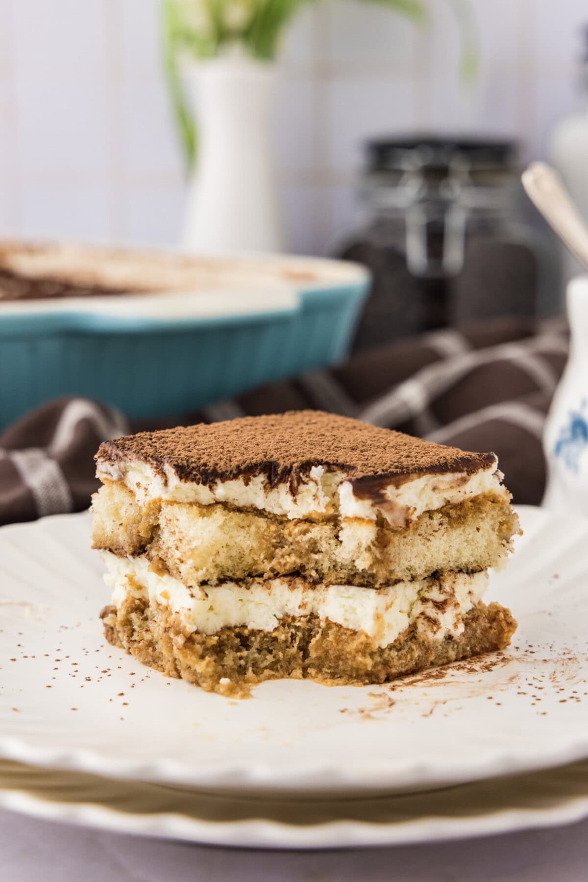 Slice of Tiramisu Icebox Cake on a plate with a bite removed