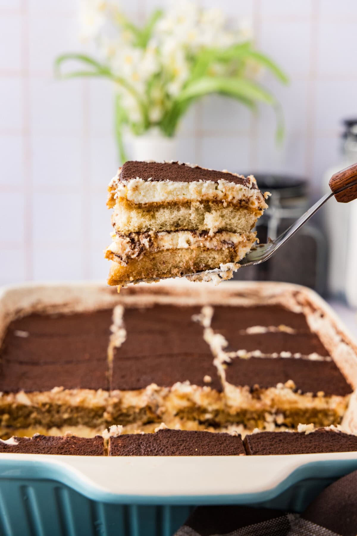 Slice of Tiramisu Icebox Cake being lifted out of the pan
