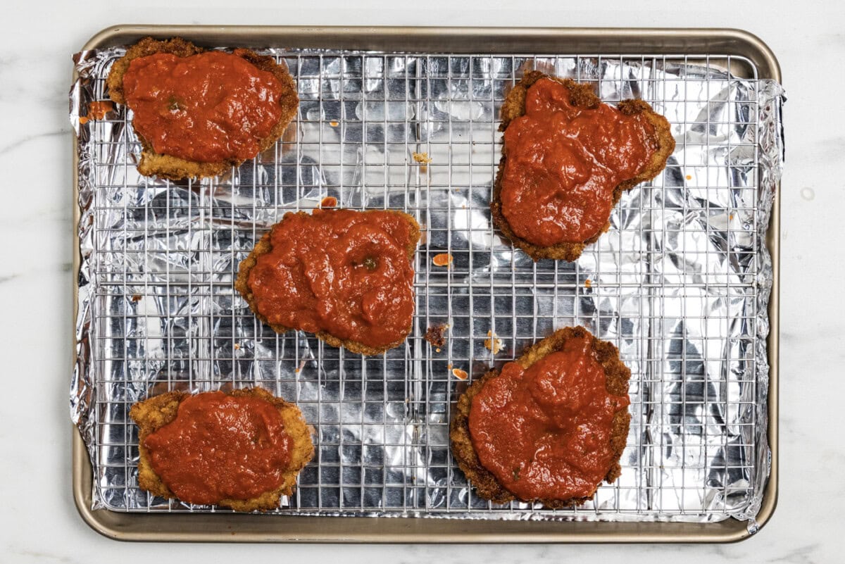 marinara sauce over cooked breaded veal cutlets