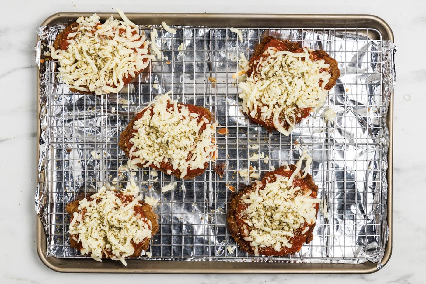 mozzarella cheese on top of marinara fried veal cutlets