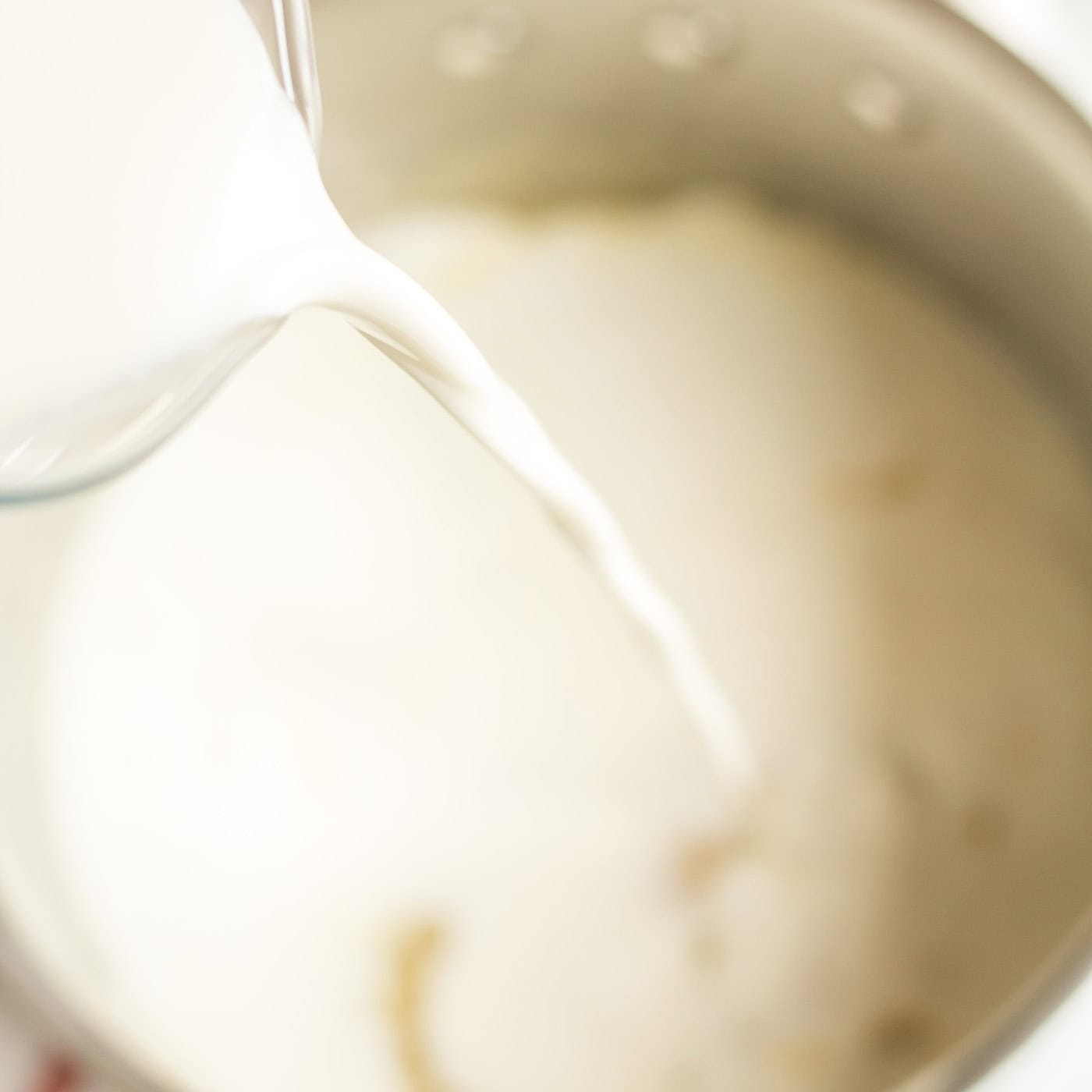 Milk being poured into a saucepan