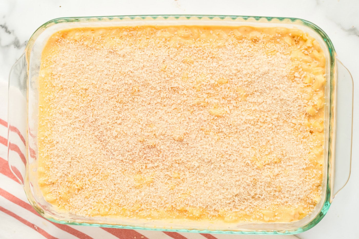 Breadcrumb mixture on top of the macaroni in a 9x13 pan