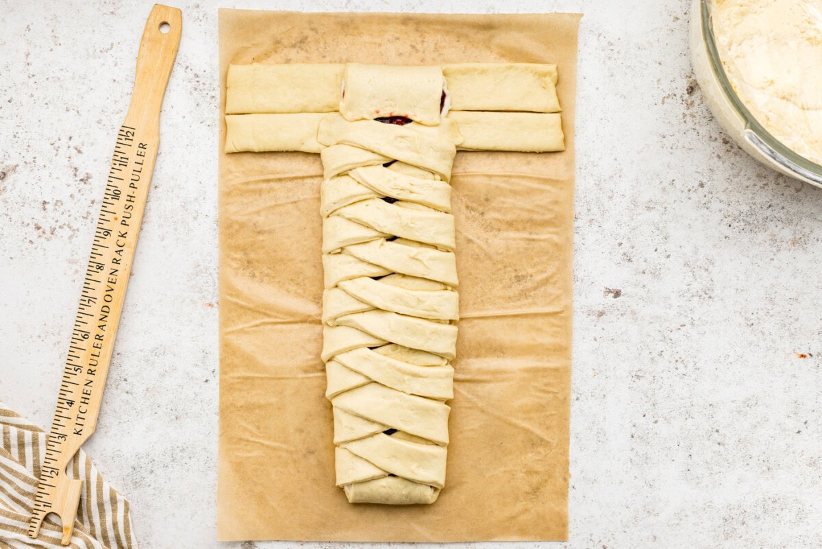 folding the end tab of the sectioned dough over the filling