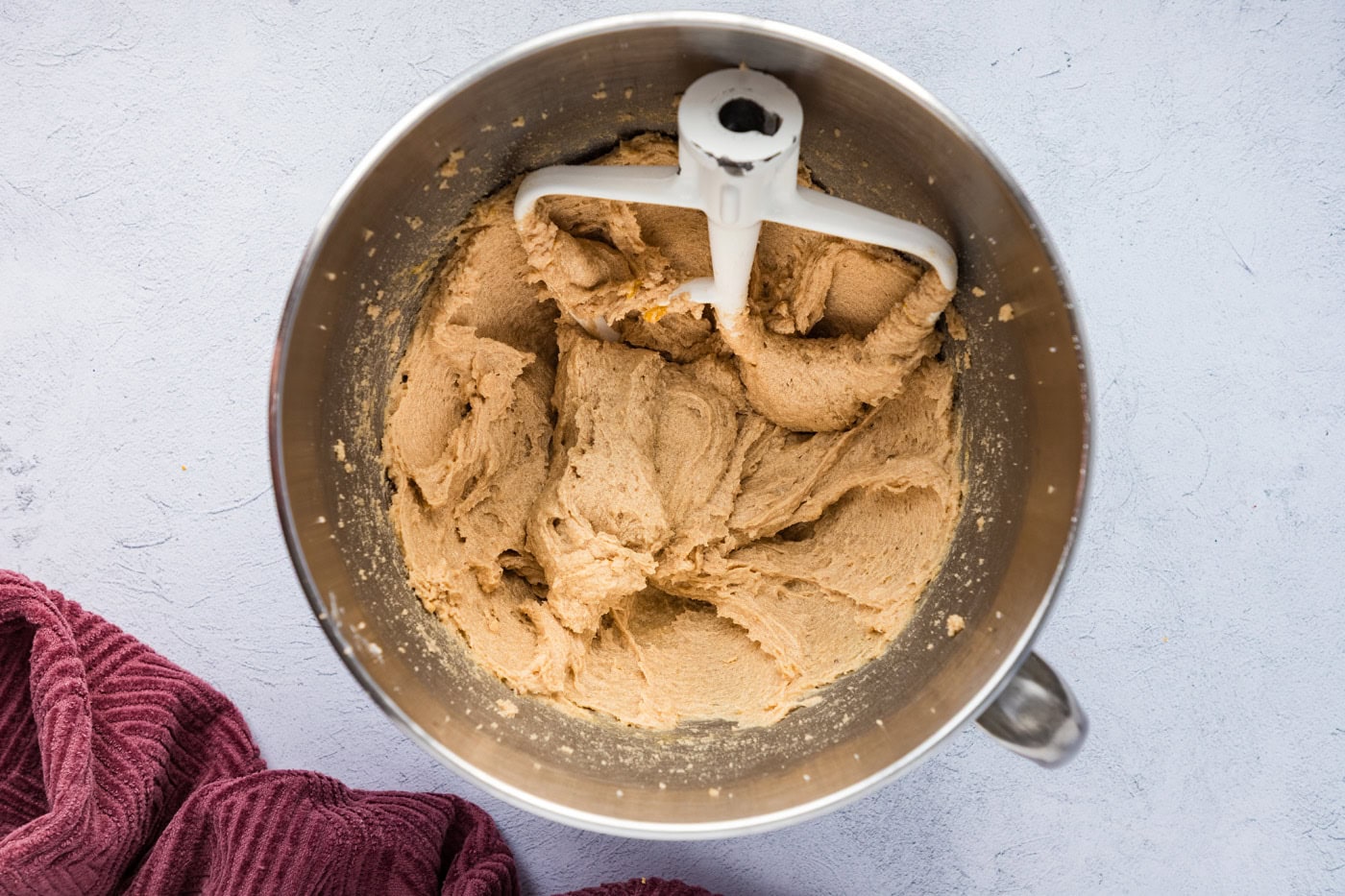 stand mixer paddle attachment in a bowl with cookie dough