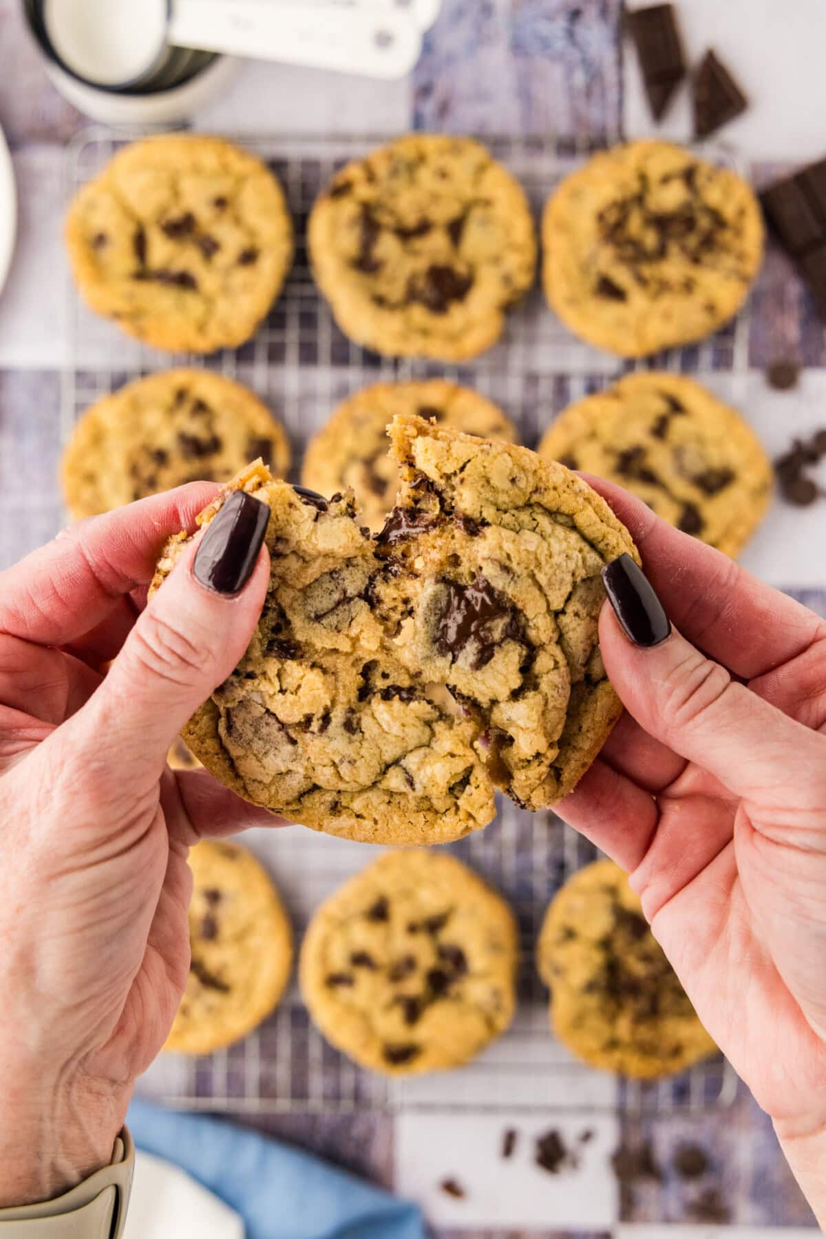 Hand breaking apart a Chocolate Chip Cookie