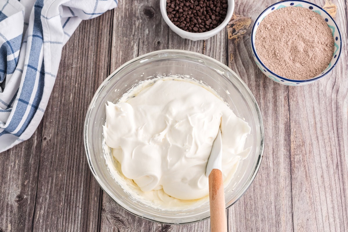 Cool whip added to the bowl of cream cheese mixture