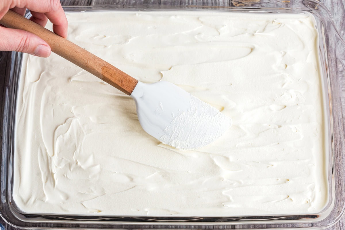 Cool whip spread over the pudding layer