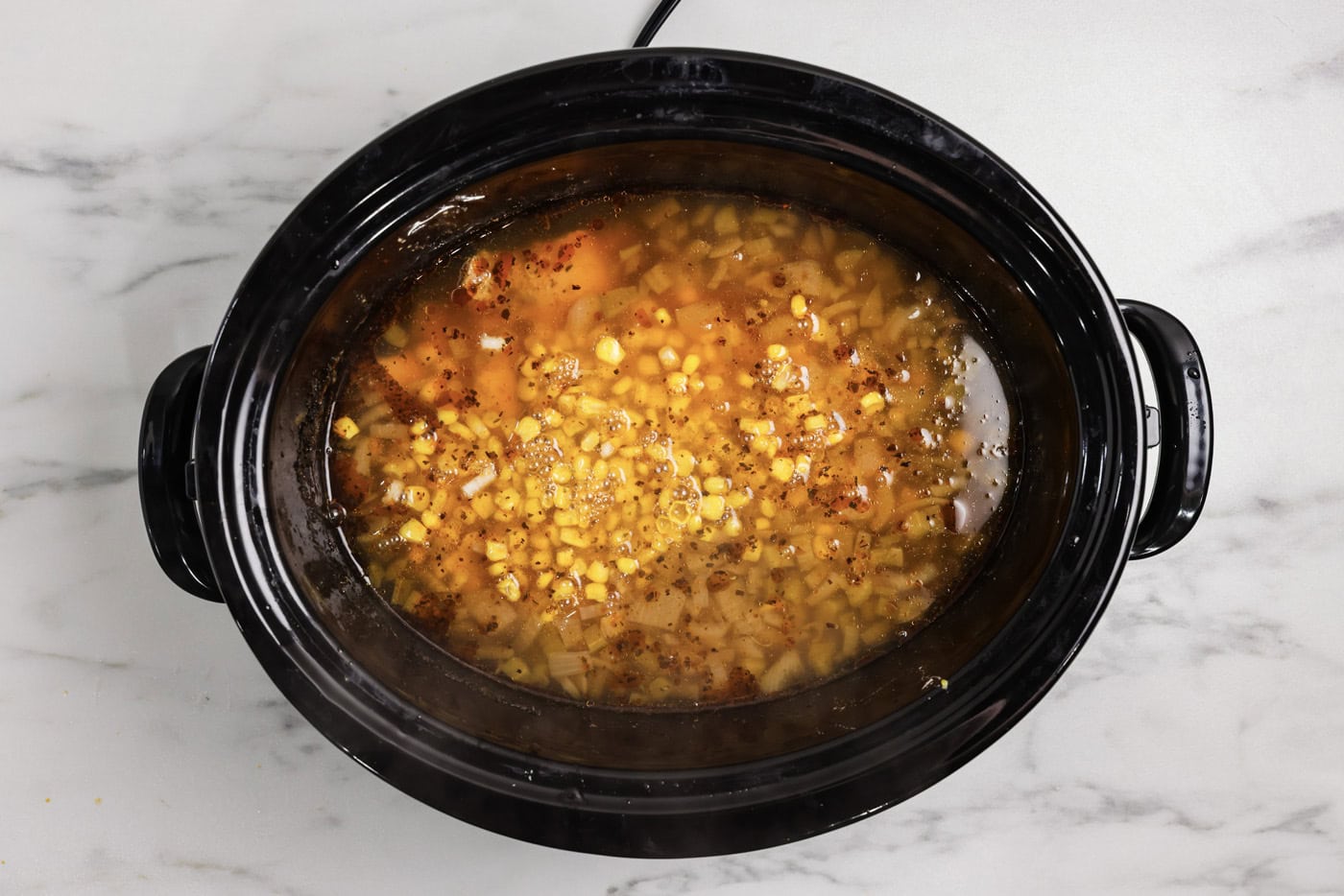 cooked white chicken chili in a slow cooker