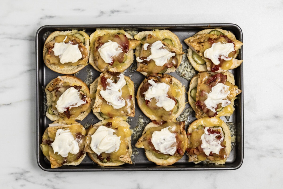 mayo dolloped on top of layered gouda chicken slider ingredients