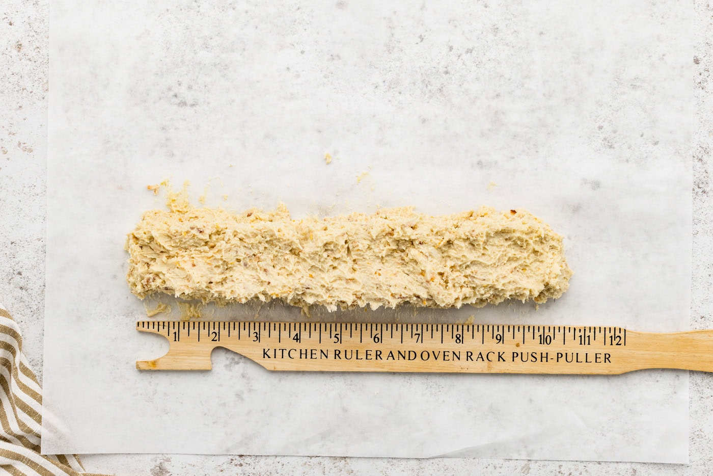 icebox cookie dough log with a ruler next to it