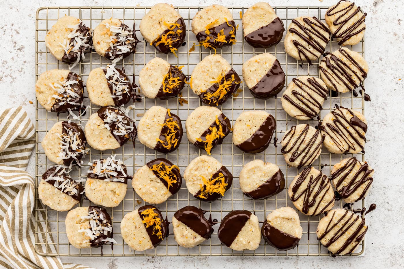 overhead photo of decorated icebox cookies on a wire cooling rack