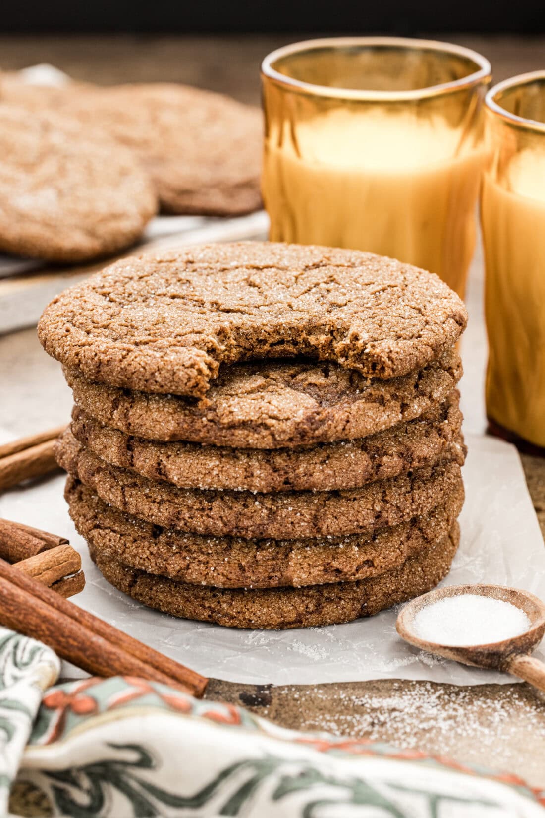 Stack of Molasses Spice Cookies with a bite taken out of the top cookie