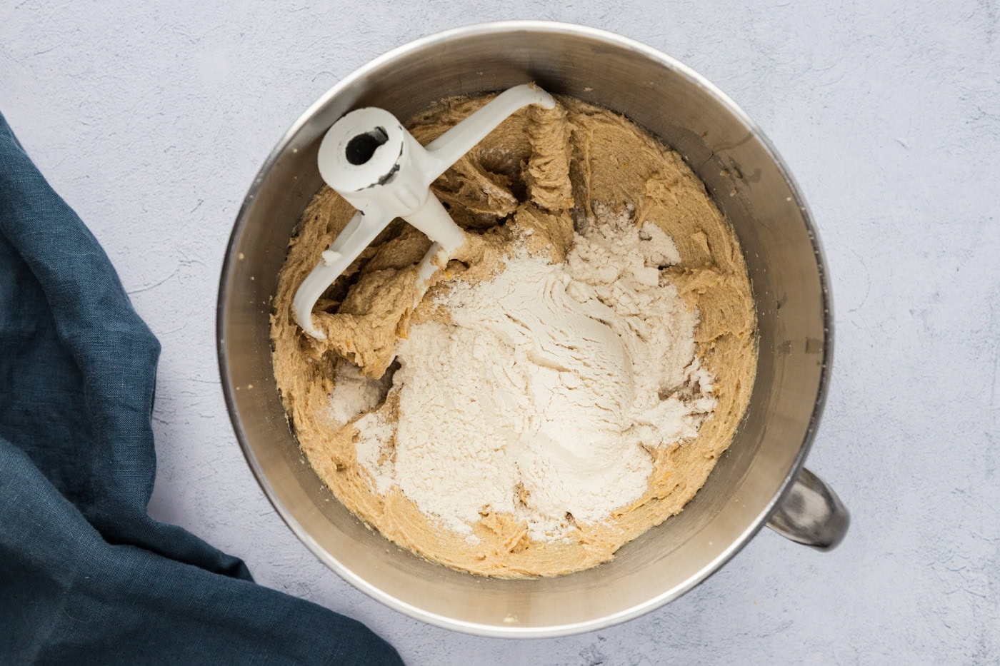 flour mixture added to creamed butter and sugars in a stand mixer bowl