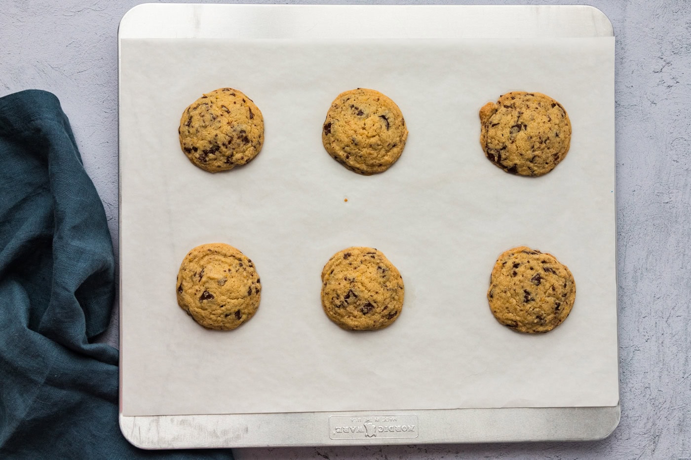 baked orange chocolate chip cookies on a baking sheet