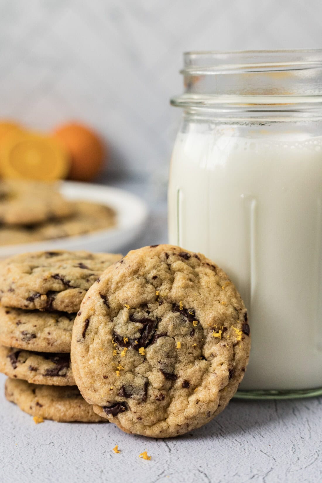 Orange Chocolate Chip Cookies resting against a glass of milk