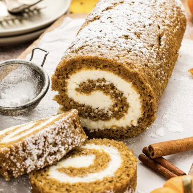 Pumpkin Cake Roll with two slices resting in front of it