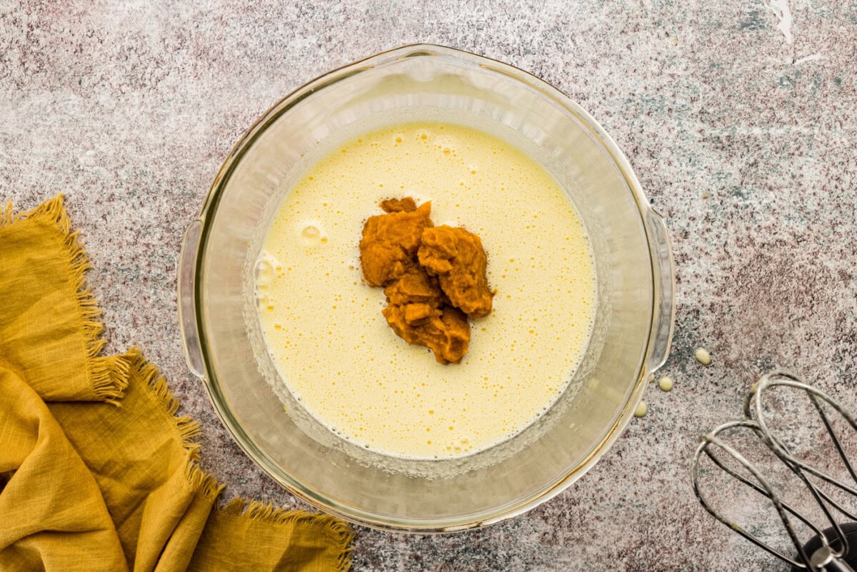 Pumpkin puree added to batter in a bowl