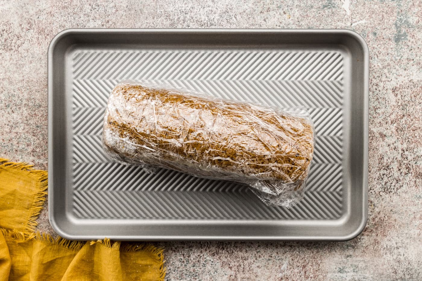 pumpkin roll wrapped with plastic wrap