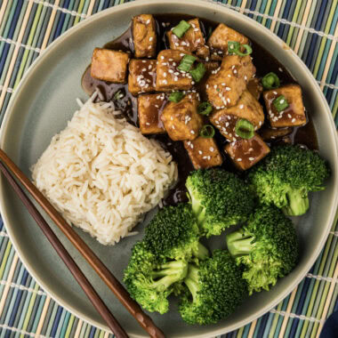 Close up photo of Teriyaki Tofu on a plate with rice and broccoli