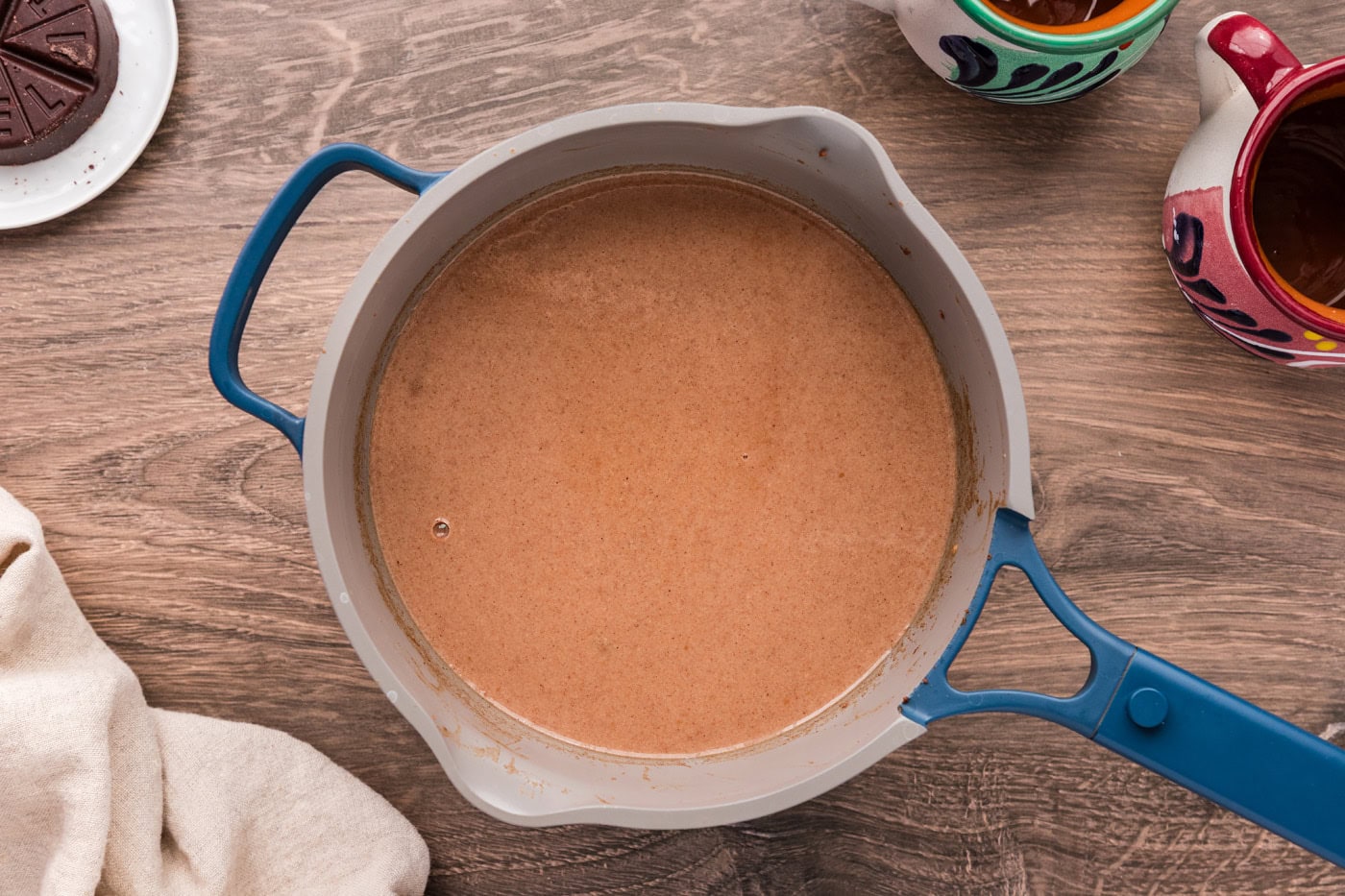 Overhead shot of champurrado Mexican hot chocolate in a large saucepan