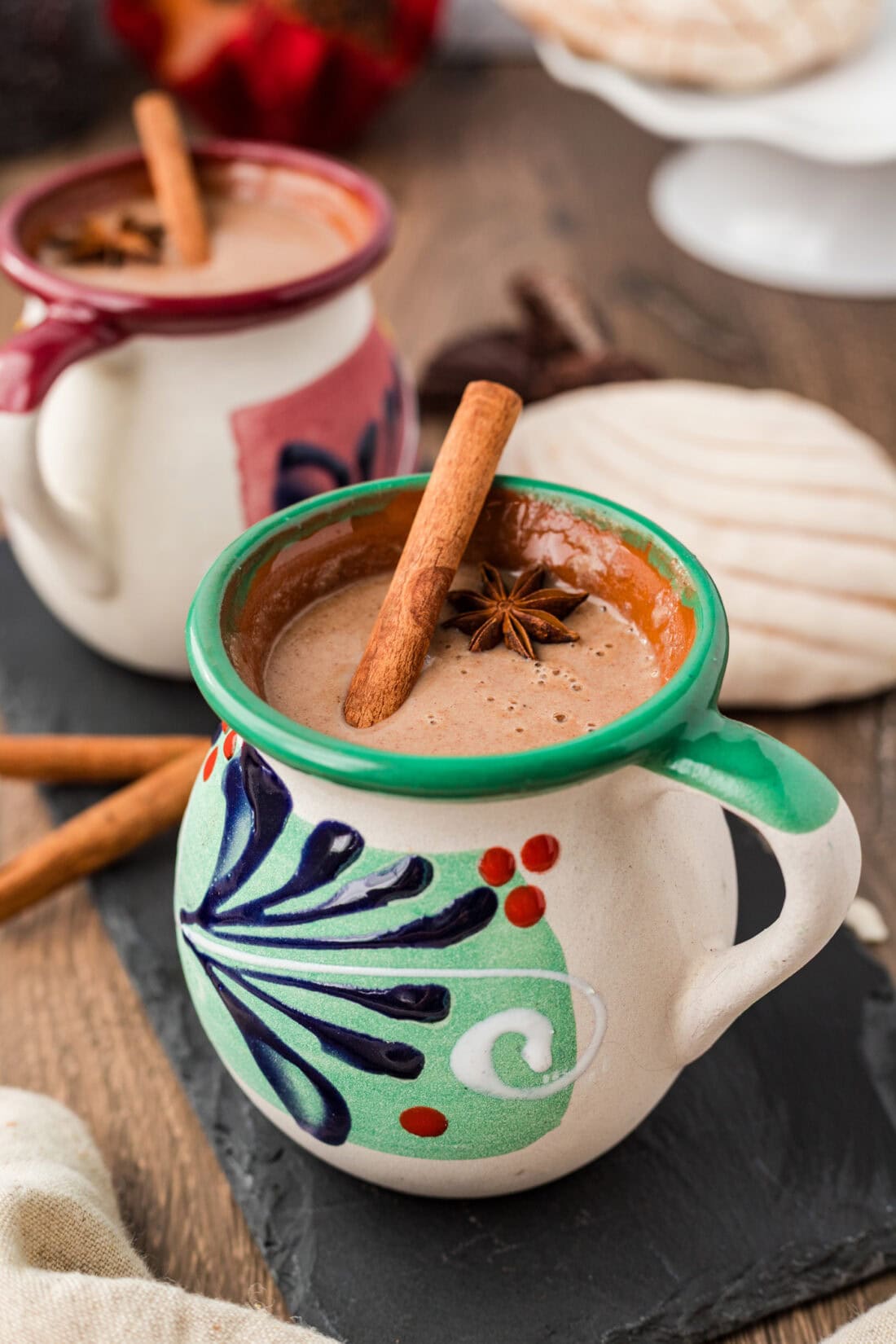 Side photo of a green mug filled with Champurrado