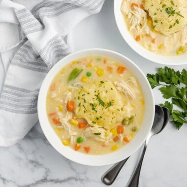 Close up photo of two bowls of Crockpot Chicken and Dumplings
