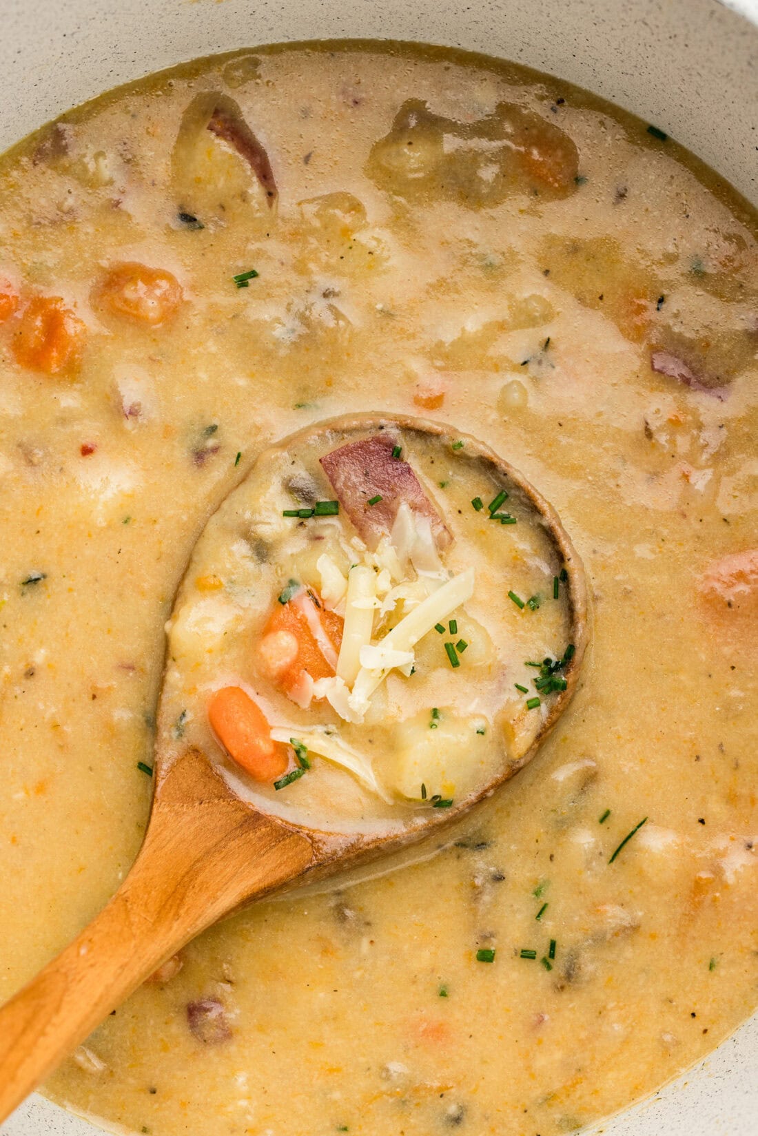 Close up photo of a ladle in a pot of Garlic Potato Soup
